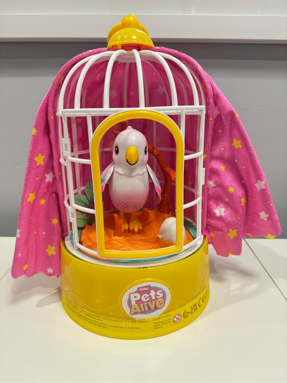 Zuru Pets Alive Bird in a cage with pink cape with yellow stars